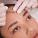 Beautiful Asian woman getting skincare treatment at beauty salon